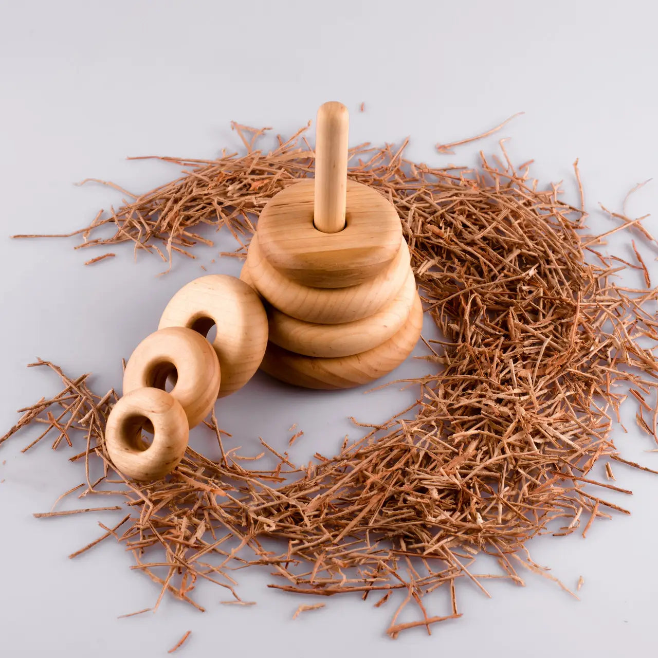 Eco-friendly wooden Montessori stacking rings for toddlers in minimalist Scandinavian design.