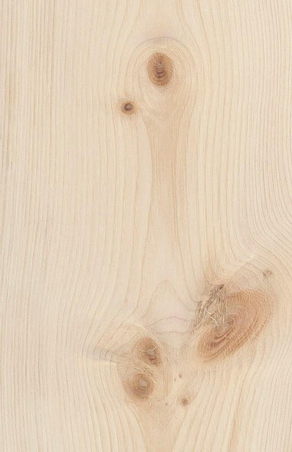 A close-up of a light natural pine wood surface with visible grain, knots, and subtle brown variations.