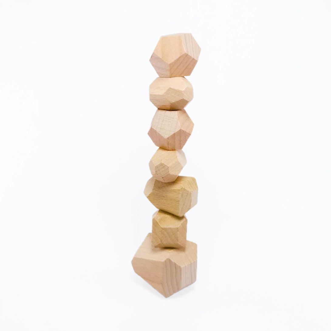 A tower built with wooden stacking stones from Forest Kids Norway.